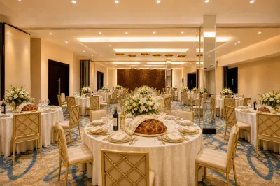 Elegant Shabbat dinner room with wine, challah, place settings, and flowers