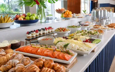 Kosher breakfast buffet with fruit, pastries, salads, and coffee